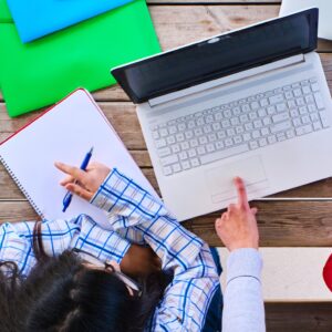 top view of a group of university students prepare a project in front of a laptop